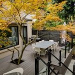 Deck building featuring raised composite deck with glass railings