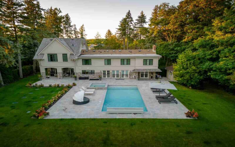 Landscaping at Oxford Rd, Toronto features built inground pool and patio