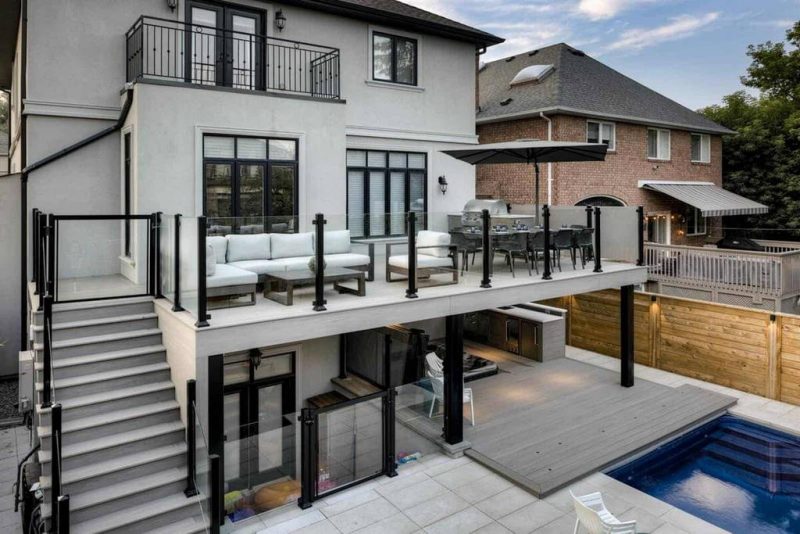 Outdoor construction and landscape design featuring Two-Story PVC Deck