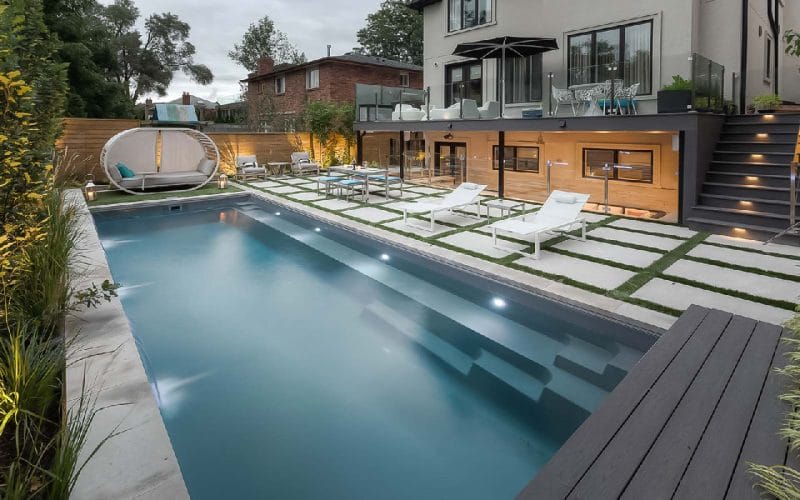 Landscaping featuring sunken composite decking, outdoor kitchen and pool built