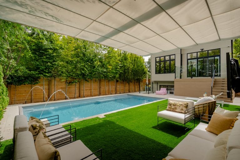 landscaping project featuring a custom inground pool and stylish flagstone patio.