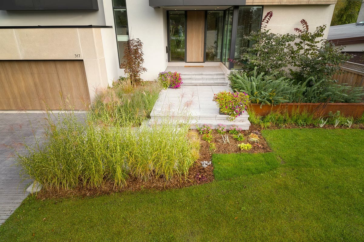 Modern Landscape Design & Construction: Front Porch Interlocking Steps, Softscaping, and Retaining Wall by a Toronto Landscaping Company