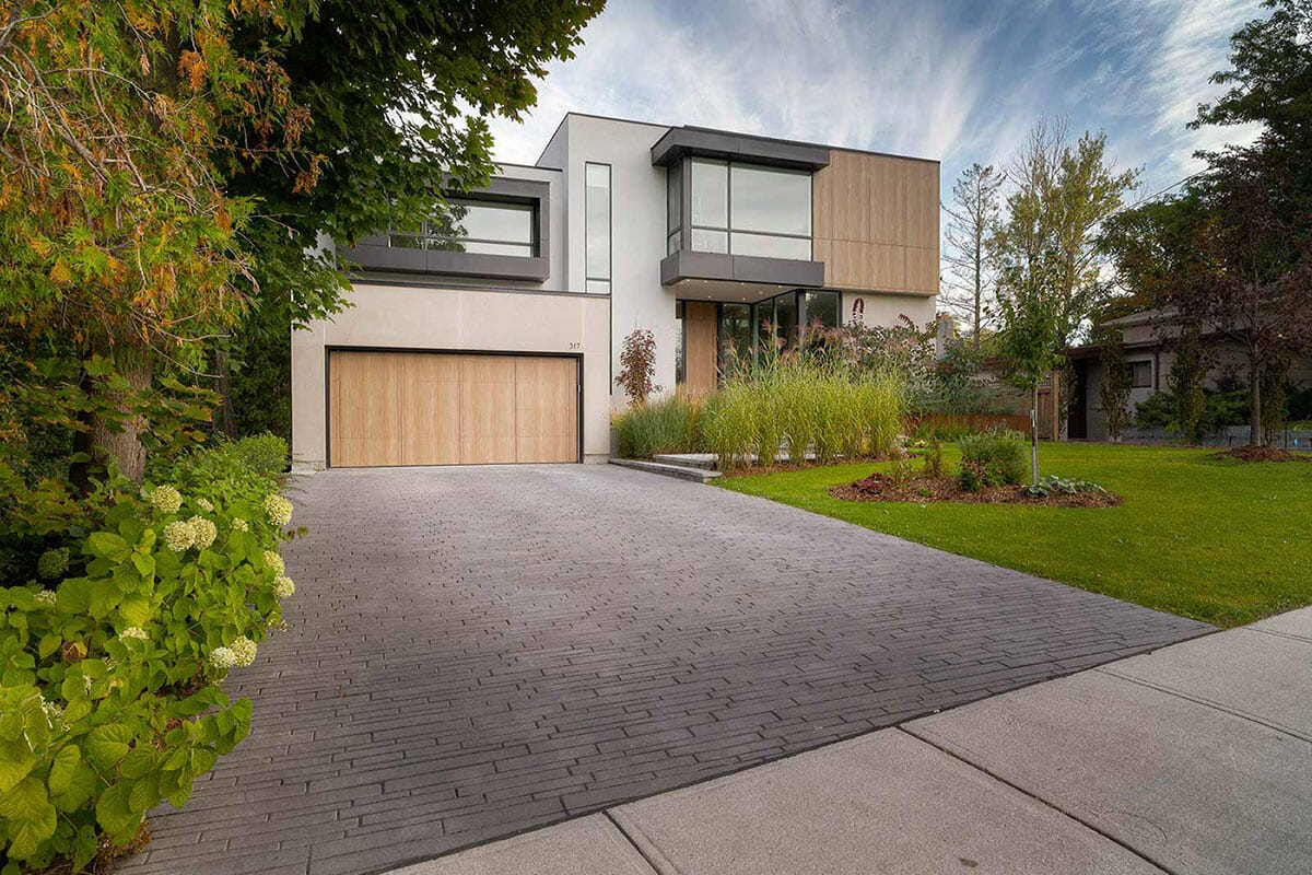 Contemporary Landscape Design with Interlocking Driveway, Landscape Planning, and Small Retaining Wall by Toronto Landscapers