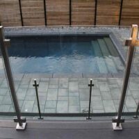 Complete Decking and Railings Project by Toronto Landscaping Company; Featuring Stainless Steel & Glass Railings, Fence Construction, Concrete Pool & Interlocking.