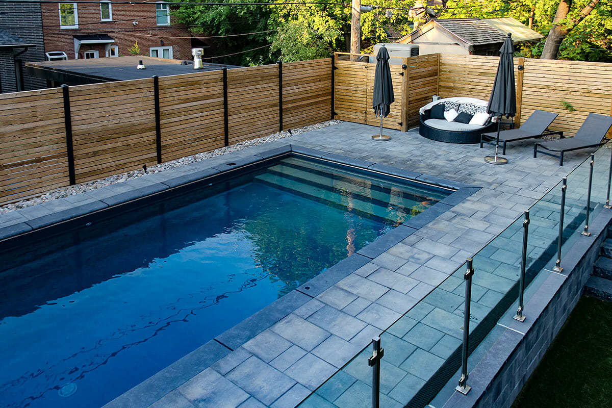 Pool Construction Project; Featuring Stainless Steel & Glass Railings installed on pool side patio