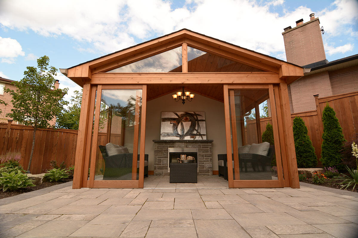 Landscaping construction Featuring cedar gazebo with outdoor fireplace, Fence & Interlocking