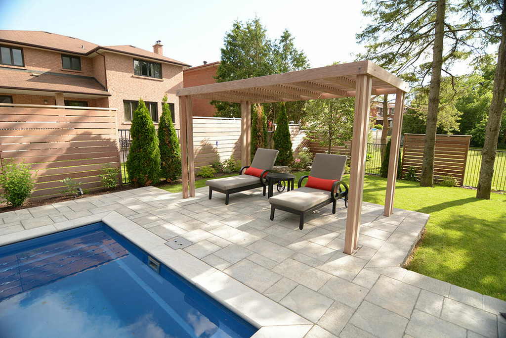 Interlocking & Fiberglass Pool Construction Project; Featuring Woodworking Pergola & IPE Privacy Fence By Toronto Landscaping Company.