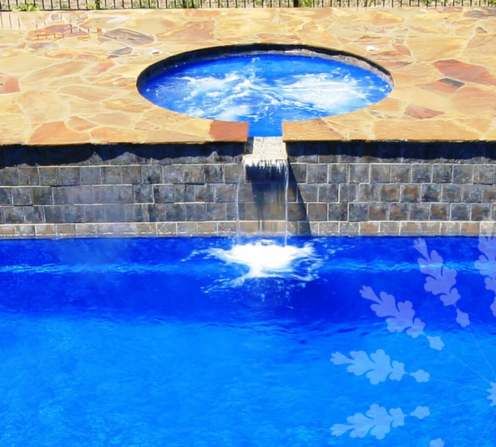 Fiberglass pool with water feature and coping