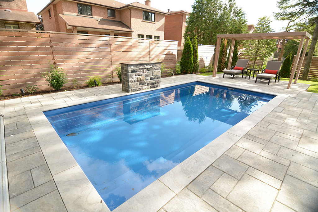 Reflection Fiberglass Pool installation with Water Feature, Interlocking & IPE Privacy Fence Backyard construction Project by Toronto pool Company.