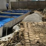 inground Fiberglass Pool and patio construction by Pool construction company