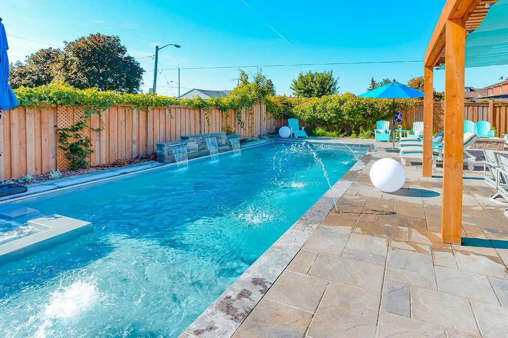 Fiberglass Pool installation with Interlock patio & pergola by Toronto’s Pool Experts