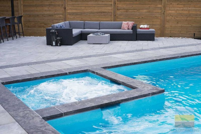 Toronto pool installation and surrounding landscape construction